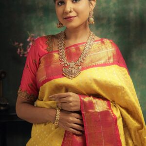 Elegant Indian woman in saree adorned with traditional gold jewelry
